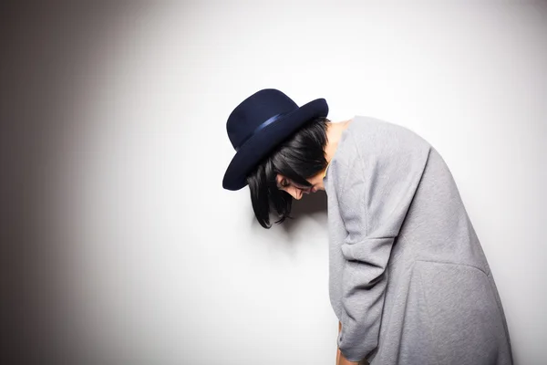 Modern woman with black hat on gray — Stock Photo, Image