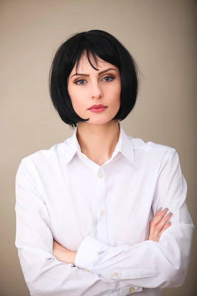 Brunette vrouw met blauwe ogen in wit overhemd geïsoleerd — Stockfoto