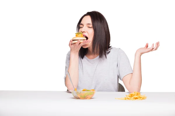 Picture of woman with fruits and hamburger in front on white bac — Stock Photo, Image