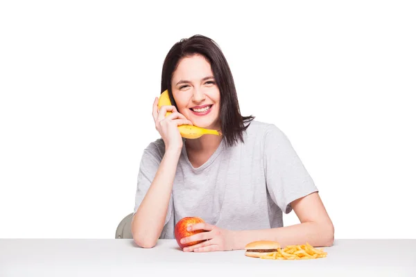 Foto de mulher com frutas e hambúrguer na frente em bac branco — Fotografia de Stock