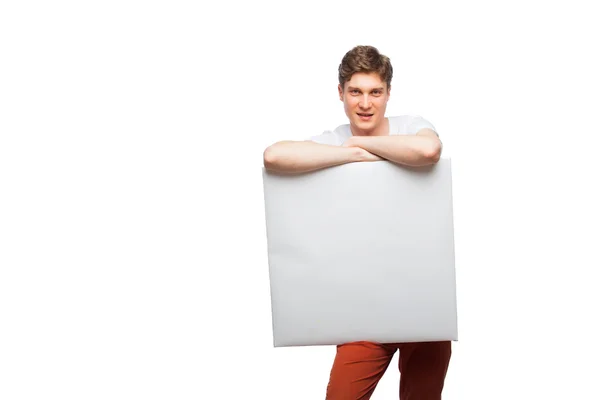 Young blonde man showing empty panel isolated on white — Stock Photo, Image