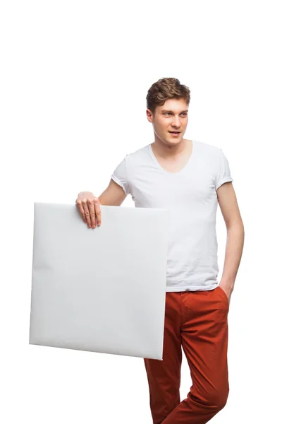 Ung blond man visar tom panel isolerad på vit — Stockfoto
