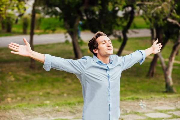 succesful man with open arms celebrating