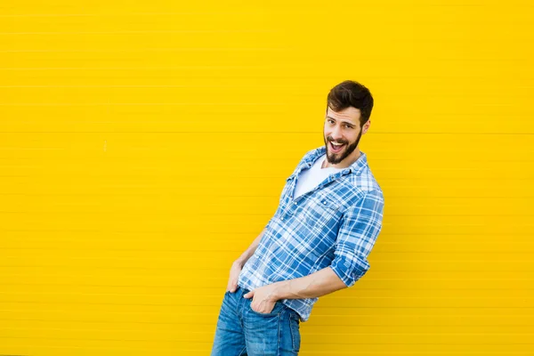Young happy man on yellow — Stock Photo, Image
