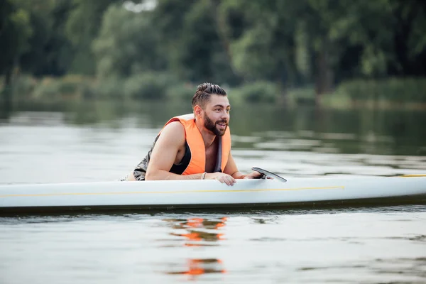 Handsome wet man on paddleboard — Stock Photo, Image