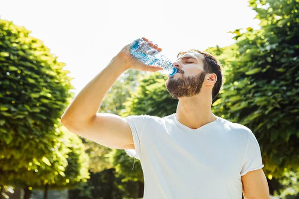 Volwassen man drinking water uit een fles buiten — Stockfoto