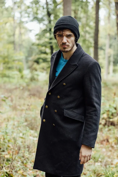 Young man with black hat in forest — Stock Photo, Image