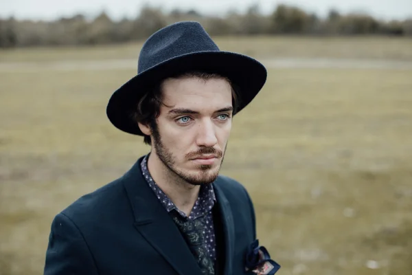 Uomo elegante su un campo verde — Foto Stock