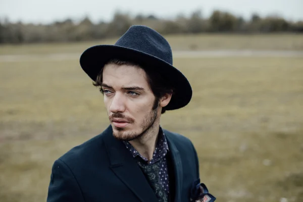 Uomo elegante su un campo verde — Foto Stock