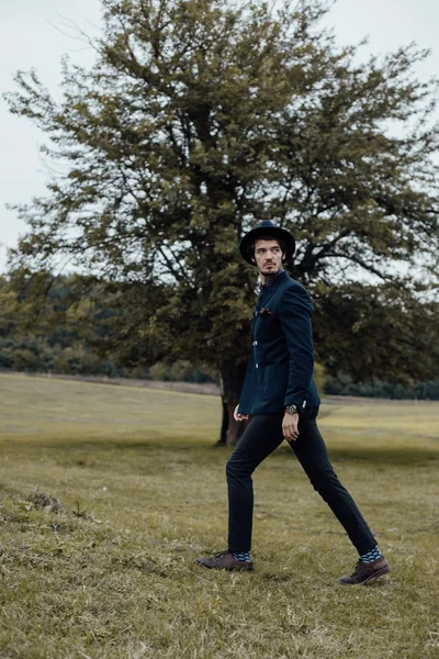 Stylish man on a green field — Stock Photo, Image