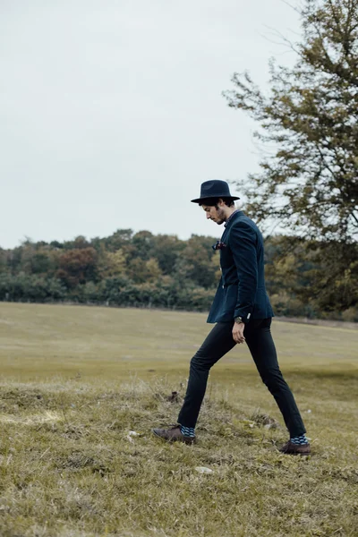 Stylish man on a green field — Stock Photo, Image