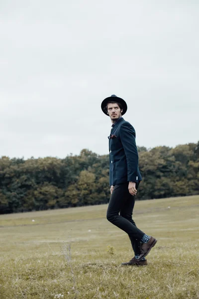 Stylish man on a green field — Stock Photo, Image