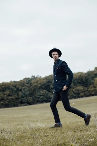 Stylish man on a green field — Stock Photo, Image