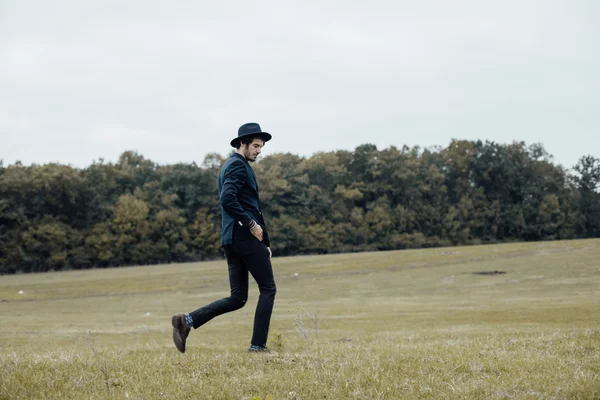 Stylish man on a green field — Stock Photo, Image