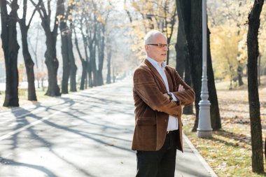 Dışarıda duran yaşlı adam şık giyinmiş