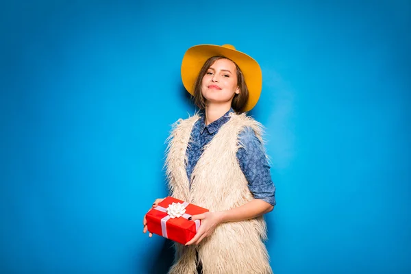 Young woman holding red gift in hands — Stock Photo, Image