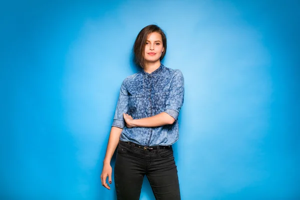 young woman casual dressed on blue background