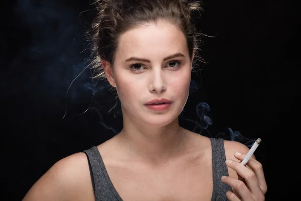 Woman smoking concept on black — Stock Photo, Image