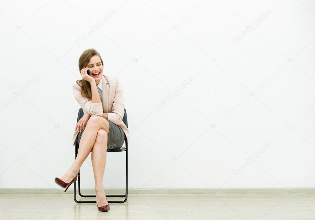 woman in office outfit waiting on a chair