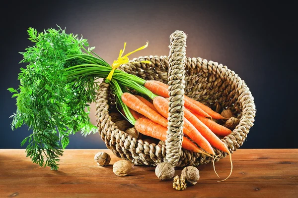 Nuts and carrots in the basket — Stock Photo, Image