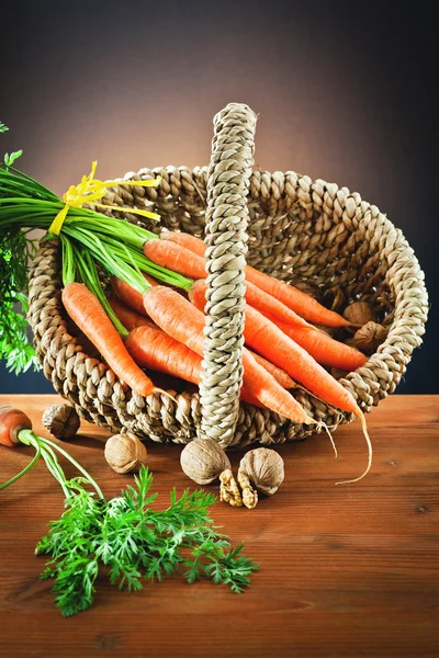 Nuts and carrots in the basket — Stock Photo, Image