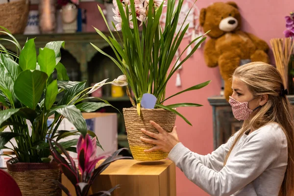 entrepreneur woman working in the flower shop after being able to reopen