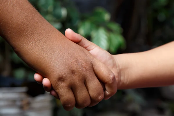 Two kids shaking hands