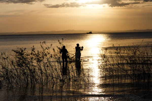 Două persoane pescuind pe lacul Nicaragua la apusul soarelui — Fotografie, imagine de stoc