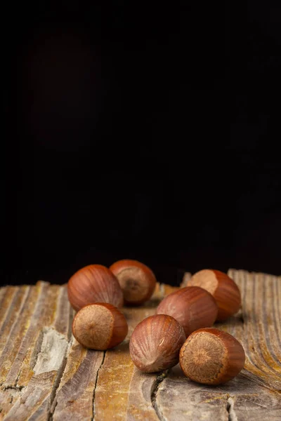 Aerial View Hazelnuts Rustic Wooden Table Black Background Vertical Copy — Stock Photo, Image