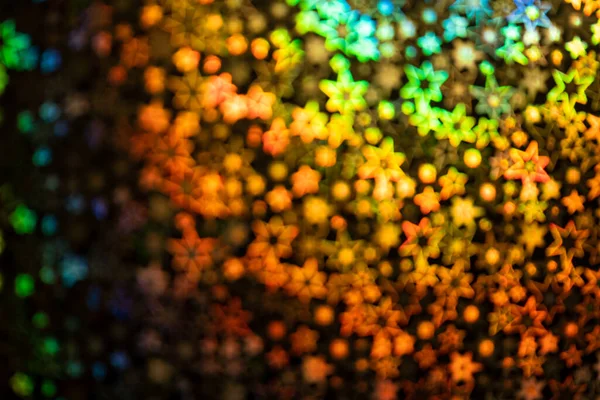 Gold stars shimmer in different shades, starry bokeh, background. Abstraction.