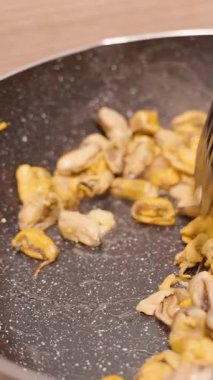 Dikey video. Yavaş Çekimde Sarımsak ve Yağla Karıştırılmış Midye Yavaş Çekimde Spatula