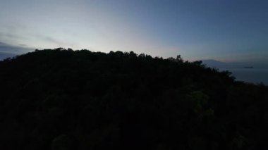 Drone Rises Above the Mountain Revealing Sunset and Houses by the Shore Discovery and Expansion Concept