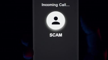 Scam Call Screen on Smartphone Slowly Moves Away as Hand Presses Red Button to Decline the Call and Screen Turns Off in Blue and Red Light
