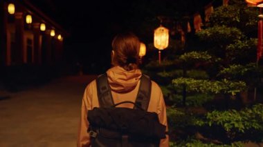 Gece Fener Yolu 'nun yanında duran gezgin. Kültürel Gece Yürüyüşü kavramını ifade eden Ilık Işıltı ve Orta Yol.