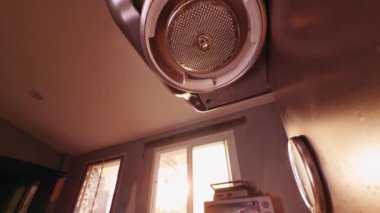 Slow Motion Low Angle View Of Espresso Machine Group Head Releasing Hot Water During Flushing Process With Droplets Falling In Warm Light Showing Cleaning And Preparation Stage