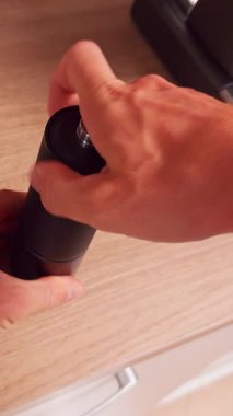 Vertical video. Top Down View Checking Grind Result in Manual Grinder Chamber Evaluating Texture and Particle Size for Espresso Extraction Control in Home Coffee Brewing Routine