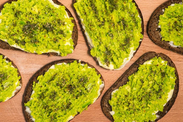 Toast with avocado close-up. Vegan dishes. Cooking background.