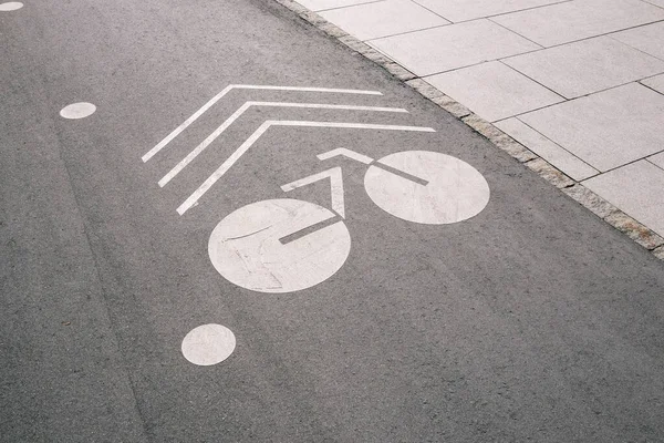 Drawn bike on the pavement. Bicycle sign on the road. Bicycle lane. Cycling road. Cyclist route. Sports and active lifestyle concept.