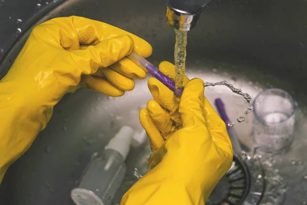 Experiments and experiments in the laboratory. A scientist in yellow gloves conducts chemical analysis and tests. The work of a doctor, beautician and researcher. Medicine and biochemistry