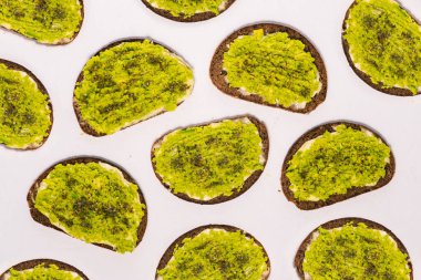 Toast with avocado isolated on a white background. Healthy and wholesome food. Fast food for breakfast, lunch or dinner. Top view, flat lay