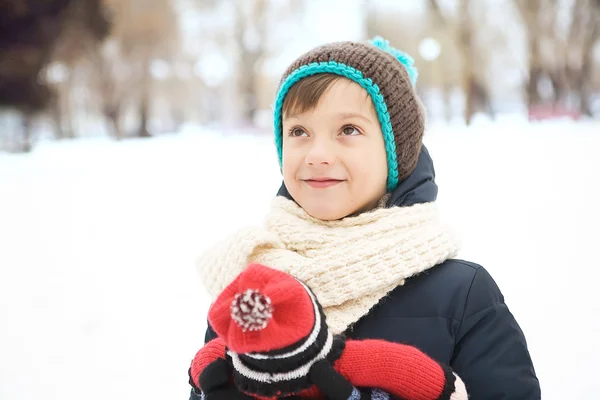 Handsome boy playing with a toy in the park in the winter in the — Stock Photo, Image