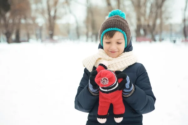 Handsome boy playing with a toy in the park in the winter in the — Stock Photo, Image