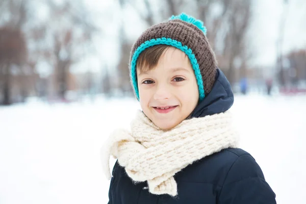 Little boy in a park smiling in winter weather — Stock Photo, Image