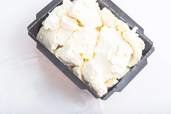 in cardboard packaging, fresh cottage cheese, on an isolated white background