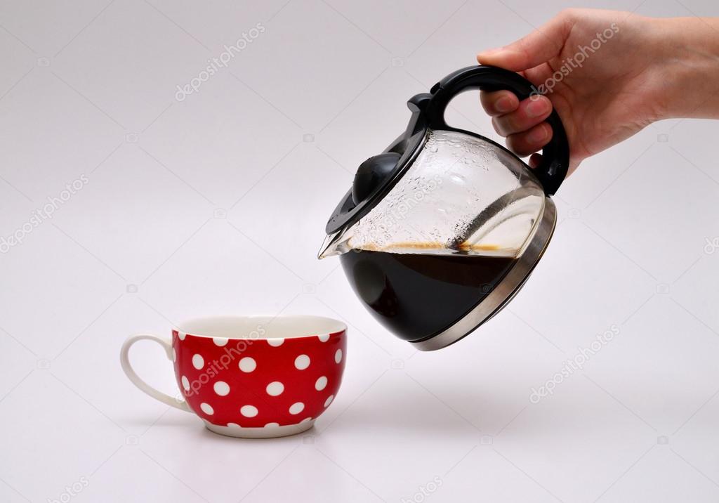 pouring coffee on a red cup