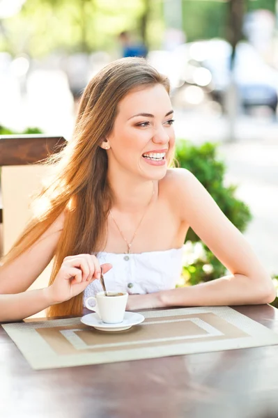Pretty woman laughing with cup of coffee — Stock Photo, Image