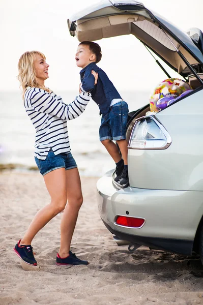 Belle femme avec un enfant près de la machine . — Photo