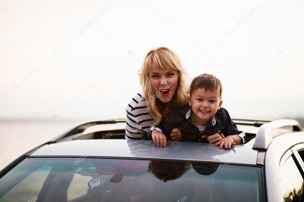 Beautiful woman with a child in the car.