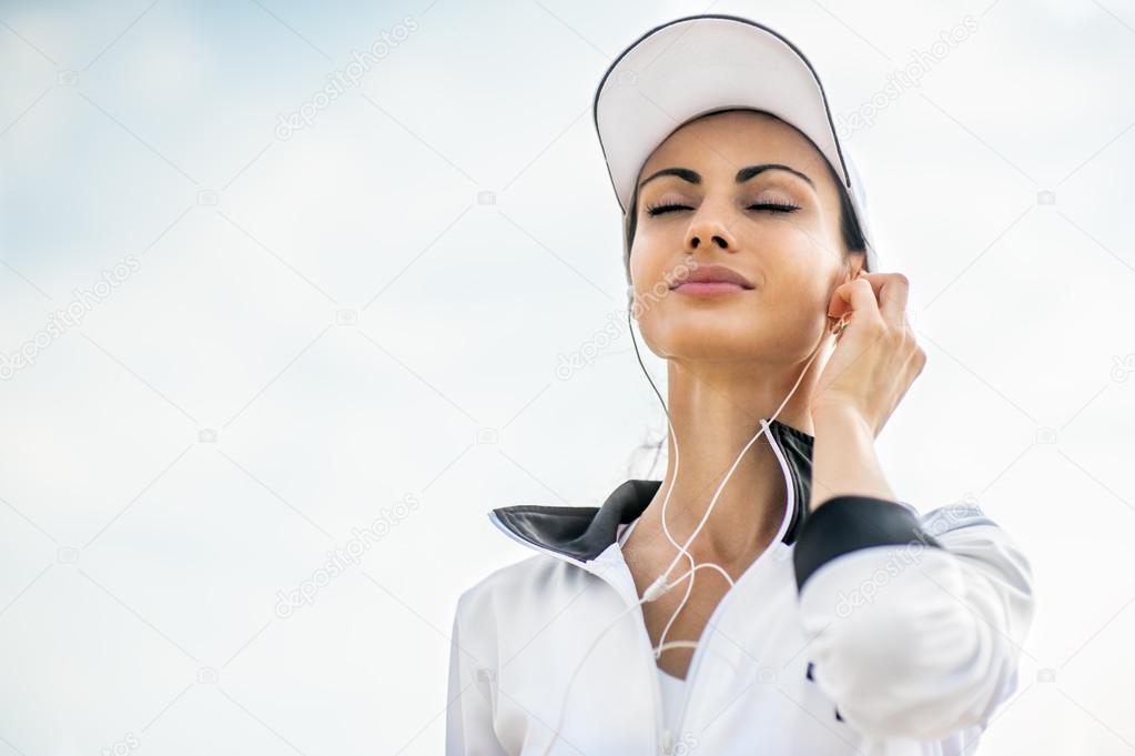 Young woman on beach listening to music