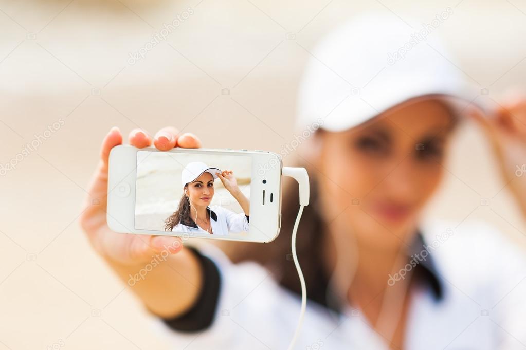 Young woman on beach listening to music